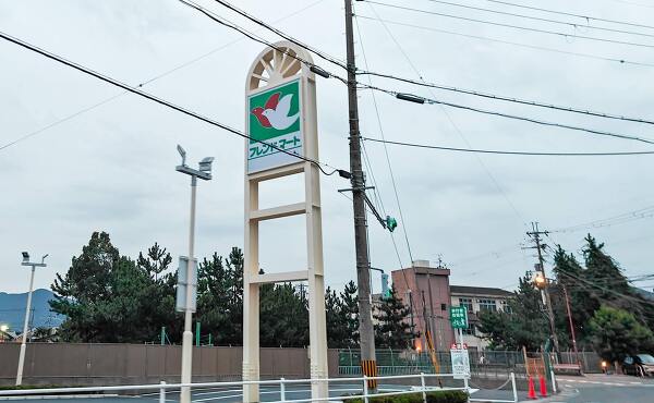 フレンドマート南郷店のポールサインと店舗の乗り入れ口(2025年11月撮影)